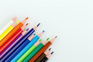 macro multicolored pencils on a white background photo