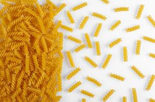 Pasta products in the form of a spiral, texture, on a white background photo