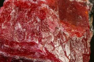 macro mineral Rhodonite stone on a black background photo