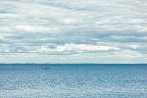 beautiful landscape of the sea against the background of a blue sky with clouds photo