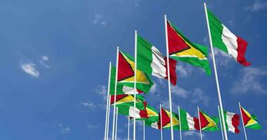 Guyana and Italy Flags Waving Together in the Sky, Seamless Loop in Wind, Space on Left Side for Design or Information, 3D Rendering video