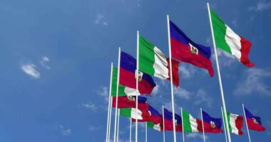 Haiti and Italy Flags Waving Together in the Sky, Seamless Loop in Wind, Space on Left Side for Design or Information, 3D Rendering video