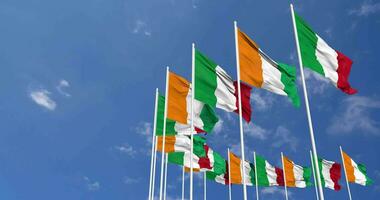 Ivory Coast and Italy Flags Waving Together in the Sky, Seamless Loop in Wind, Space on Left Side for Design or Information, 3D Rendering video