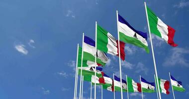 Lesotho and Italy Flags Waving Together in the Sky, Seamless Loop in Wind, Space on Left Side for Design or Information, 3D Rendering video