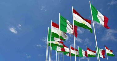 Tajikistan and Italy Flags Waving Together in the Sky, Seamless Loop in Wind, Space on Left Side for Design or Information, 3D Rendering video