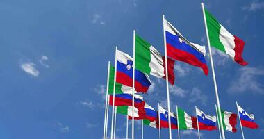 Slovenia and Italy Flags Waving Together in the Sky, Seamless Loop in Wind, Space on Left Side for Design or Information, 3D Rendering video