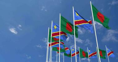 DR Congo and Bangladesh Flags Waving Together in the Sky, Seamless Loop in Wind, Space on Left Side for Design or Information, 3D Rendering video