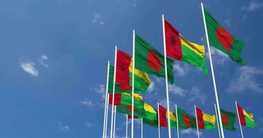 Guinea Bissau and Bangladesh Flags Waving Together in the Sky, Seamless Loop in Wind, Space on Left Side for Design or Information, 3D Rendering video