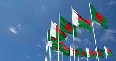 Madagascar and Bangladesh Flags Waving Together in the Sky, Seamless Loop in Wind, Space on Left Side for Design or Information, 3D Rendering video