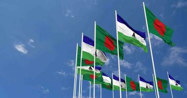 Lesotho and Bangladesh Flags Waving Together in the Sky, Seamless Loop in Wind, Space on Left Side for Design or Information, 3D Rendering video