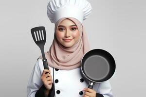 AI generated an Asian female chef in a hijab holding a spatula on a white background photo