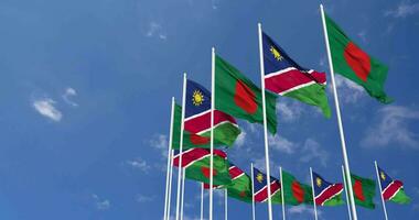 Namibia and Bangladesh Flags Waving Together in the Sky, Seamless Loop in Wind, Space on Left Side for Design or Information, 3D Rendering video