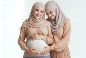 AI generated Asian woman in hijab with pose holding pregnant belly and smiling facial expression isolated white background photo