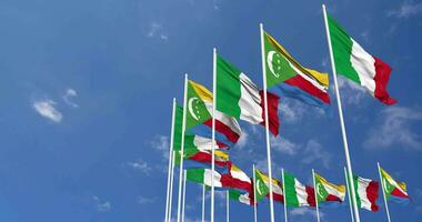 Comoros and Italy Flags Waving Together in the Sky, Seamless Loop in Wind, Space on Left Side for Design or Information, 3D Rendering video