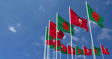 Isle of Man and Bangladesh Flags Waving Together in the Sky, Seamless Loop in Wind, Space on Left Side for Design or Information, 3D Rendering video