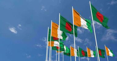 Ivory Coast and Bangladesh Flags Waving Together in the Sky, Seamless Loop in Wind, Space on Left Side for Design or Information, 3D Rendering video