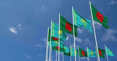 kazakhstan och bangladesh flaggor vinka tillsammans i de himmel, sömlös slinga i vind, Plats på vänster sida för design eller information, 3d tolkning video