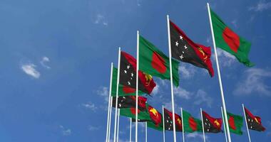 Papua New Guinea and Bangladesh Flags Waving Together in the Sky, Seamless Loop in Wind, Space on Left Side for Design or Information, 3D Rendering video