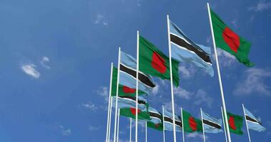 Botswana and Bangladesh Flags Waving Together in the Sky, Seamless Loop in Wind, Space on Left Side for Design or Information, 3D Rendering video