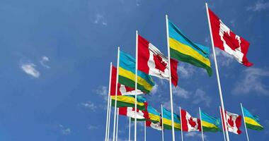 Rwanda and Canada Flags Waving Together in the Sky, Seamless Loop in Wind, Space on Left Side for Design or Information, 3D Rendering video