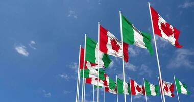 Nigeria and Canada Flags Waving Together in the Sky, Seamless Loop in Wind, Space on Left Side for Design or Information, 3D Rendering video