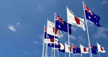 Australia and Japan Flags Waving Together in the Sky, Seamless Loop in Wind, Space on Left Side for Design or Information, 3D Rendering video