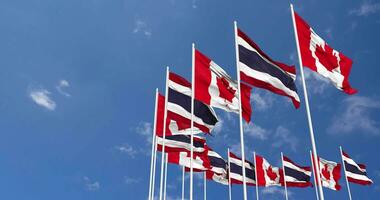 Thailand and Canada Flags Waving Together in the Sky, Seamless Loop in Wind, Space on Left Side for Design or Information, 3D Rendering video