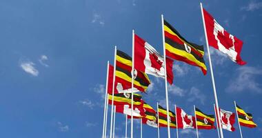 Uganda and Canada Flags Waving Together in the Sky, Seamless Loop in Wind, Space on Left Side for Design or Information, 3D Rendering video