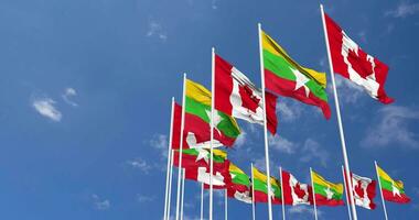 Myanmar, Burma and Canada Flags Waving Together in the Sky, Seamless Loop in Wind, Space on Left Side for Design or Information, 3D Rendering video