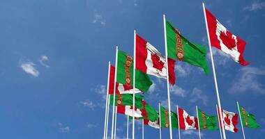 Turkmenistan and Canada Flags Waving Together in the Sky, Seamless Loop in Wind, Space on Left Side for Design or Information, 3D Rendering video
