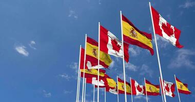 Spain and Canada Flags Waving Together in the Sky, Seamless Loop in Wind, Space on Left Side for Design or Information, 3D Rendering video