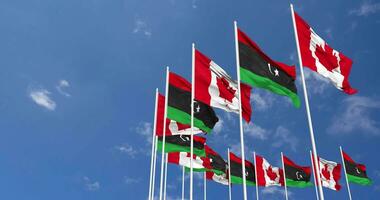 Libya and Canada Flags Waving Together in the Sky, Seamless Loop in Wind, Space on Left Side for Design or Information, 3D Rendering video