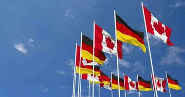 Germany and Canada Flags Waving Together in the Sky, Seamless Loop in Wind, Space on Left Side for Design or Information, 3D Rendering video