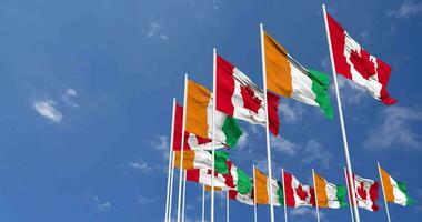 Ivory Coast and Canada Flags Waving Together in the Sky, Seamless Loop in Wind, Space on Left Side for Design or Information, 3D Rendering video