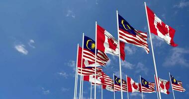 Malaysia and Canada Flags Waving Together in the Sky, Seamless Loop in Wind, Space on Left Side for Design or Information, 3D Rendering video