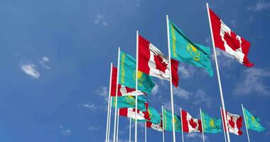 kazakhstan och kanada flaggor vinka tillsammans i de himmel, sömlös slinga i vind, Plats på vänster sida för design eller information, 3d tolkning video