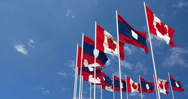 Laos and Canada Flags Waving Together in the Sky, Seamless Loop in Wind, Space on Left Side for Design or Information, 3D Rendering video