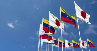 Bolivarian Republic of Venezuela and Japan Flags Waving Together in the Sky, Seamless Loop in Wind, Space on Left Side for Design or Information, 3D Rendering video