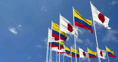 Colombia and Japan Flags Waving Together in the Sky, Seamless Loop in Wind, Space on Left Side for Design or Information, 3D Rendering video