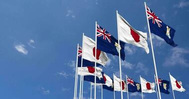 Anguilla and Japan Flags Waving Together in the Sky, Seamless Loop in Wind, Space on Left Side for Design or Information, 3D Rendering video