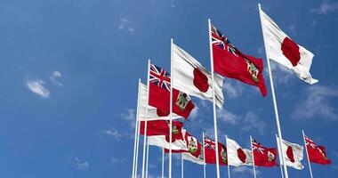 Bermuda and Japan Flags Waving Together in the Sky, Seamless Loop in Wind, Space on Left Side for Design or Information, 3D Rendering video