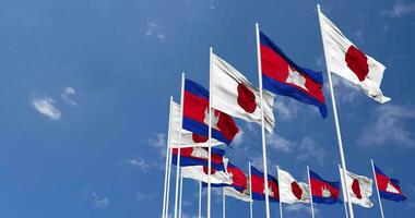 Cambodia and Japan Flags Waving Together in the Sky, Seamless Loop in Wind, Space on Left Side for Design or Information, 3D Rendering video