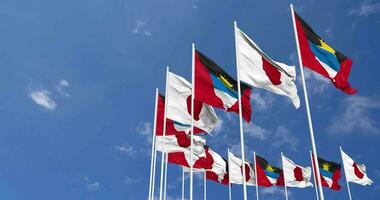 Antigua and Barbuda and Japan Flags Waving Together in the Sky, Seamless Loop in Wind, Space on Left Side for Design or Information, 3D Rendering video