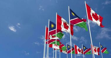 Namibia and Canada Flags Waving Together in the Sky, Seamless Loop in Wind, Space on Left Side for Design or Information, 3D Rendering video