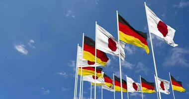 Germany and Japan Flags Waving Together in the Sky, Seamless Loop in Wind, Space on Left Side for Design or Information, 3D Rendering video