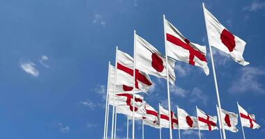 England and Japan Flags Waving Together in the Sky, Seamless Loop in Wind, Space on Left Side for Design or Information, 3D Rendering video