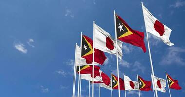 East Timor and Japan Flags Waving Together in the Sky, Seamless Loop in Wind, Space on Left Side for Design or Information, 3D Rendering video