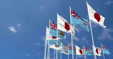 Fiji y Japón banderas ondulación juntos en el cielo, sin costura lazo en viento, espacio en izquierda lado para diseño o información, 3d representación video