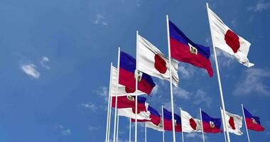 Haiti and Japan Flags Waving Together in the Sky, Seamless Loop in Wind, Space on Left Side for Design or Information, 3D Rendering video