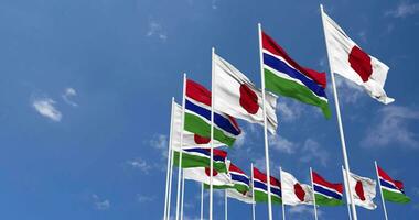 Gambia and Japan Flags Waving Together in the Sky, Seamless Loop in Wind, Space on Left Side for Design or Information, 3D Rendering video